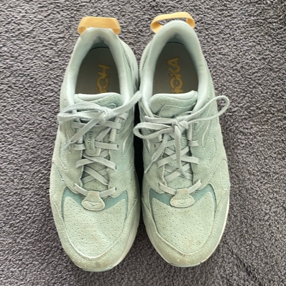 - Hoka One One Clifton L, Size 12 Women’s, Size 11 Men, Light Blue Suede